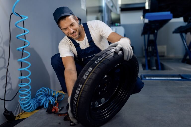 happy-repairman-checking-car-tire-service-workshop (1)